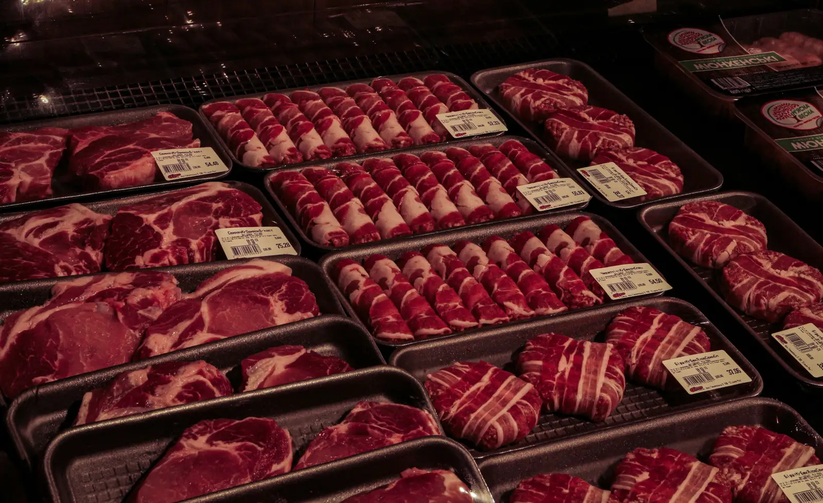 Trays of packed fresh meat in a chilled display